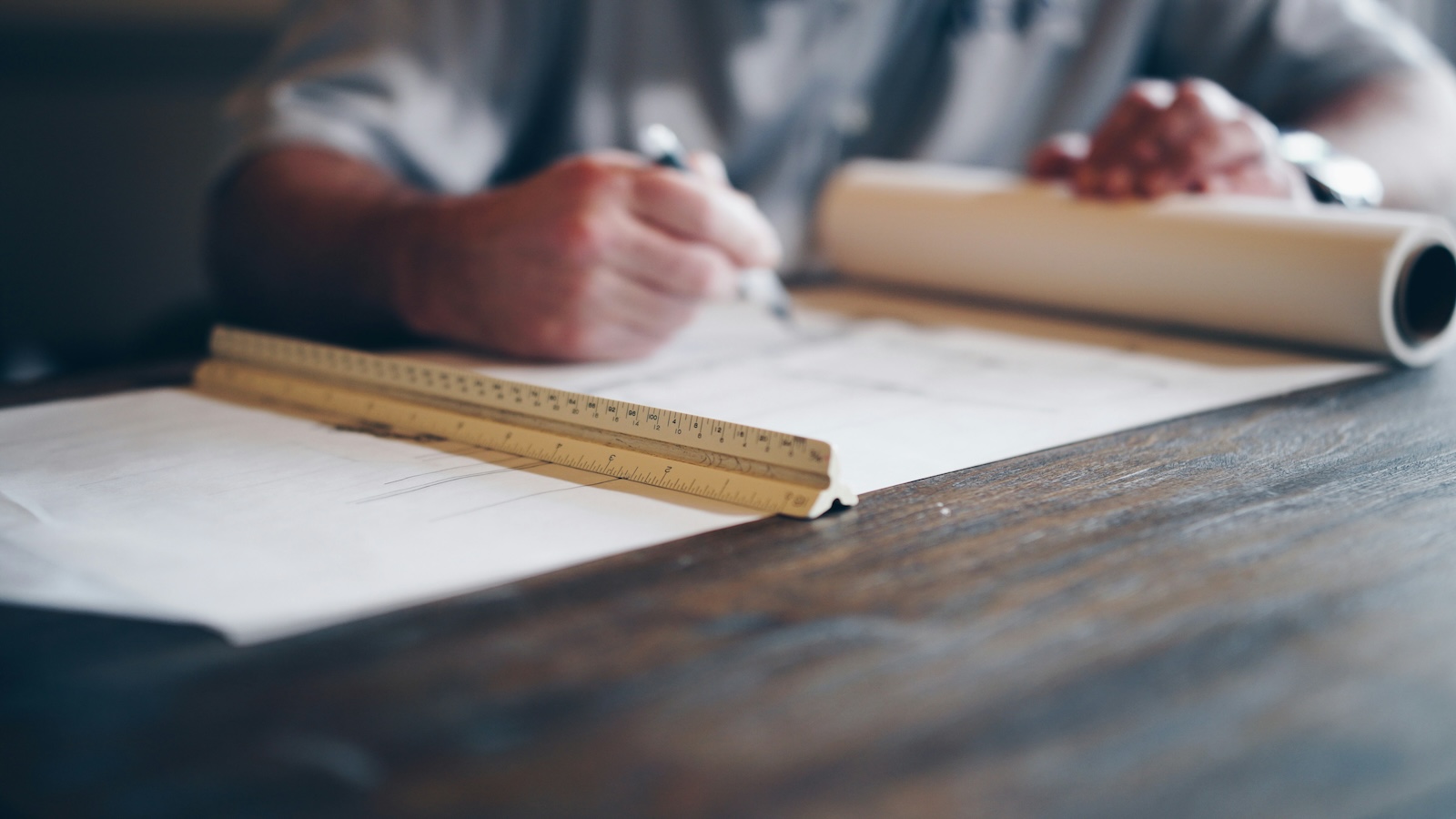 Man holding a pen drawing on paper
